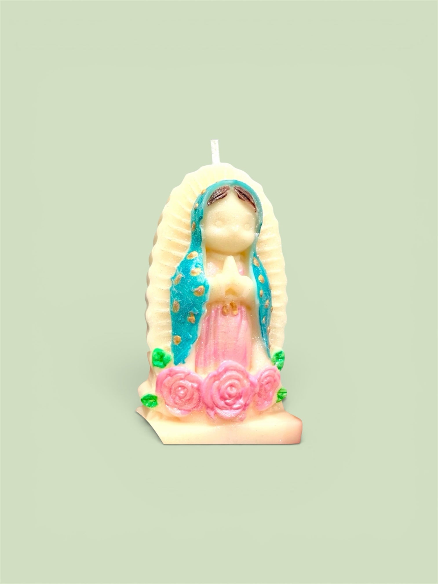 Trinity Candle Co. Our Lady of Guadalupe figural candle with teal mantle, pink gown, and sculpted rose base.